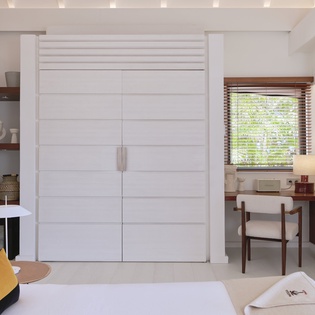Your elegantly designed room features built-in storage, a comfortable workspace with garden views, and plush linens—everything you need for a restful, productive stay.