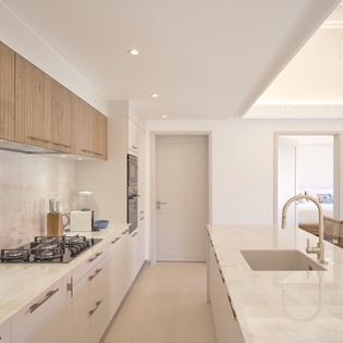 Your spacious modern kitchen flows seamlessly into the dining area, featuring premium appliances and gleaming countertops perfect for preparing memorable meals.