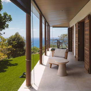 Unwind on your private terrace, where sea breezes meet modern comfort and endless ocean views stretch beyond the lush garden.