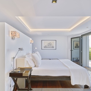Drift off to sleep in your serene bedroom, where soft ambient lighting and mountain views create the perfect retreat for peaceful nights.