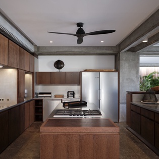 Your sleek modern kitchen blends warm wood with cool concrete, featuring premium appliances and ample prep space for memorable meals.