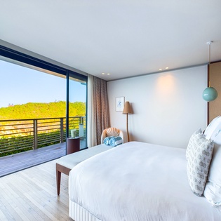 Wake up to breathtaking sea views through floor-to-ceiling windows in your serene bedroom sanctuary with direct balcony access.