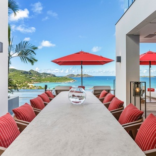 Enjoy alfresco dining at this stunning outdoor table with breathtaking ocean views and tropical breezes.