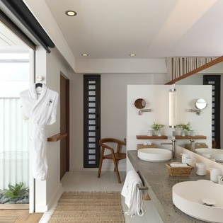 Step into your serene spa-inspired bathroom, where natural light floods the dual-sink vanity and plush robes await your arrival after a refreshing soak.