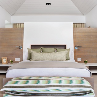 Relax in your serene bedroom with stylish wood accents, soft linens, and a peaceful atmosphere perfect for unwinding.