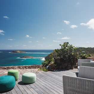 Relax on your private terrace with stunning ocean views, where comfortable seating meets endless turquoise waters and tropical breezes.