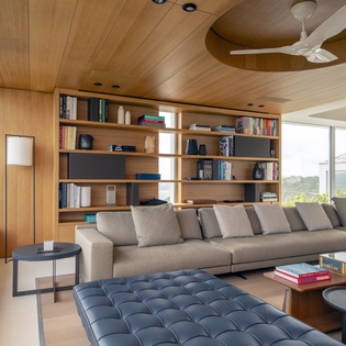Sink into the plush sectional while browsing books from your built-in library wall, all beneath stunning wood ceilings.