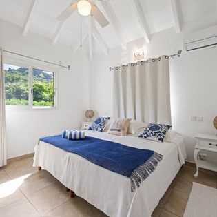 Relax in your serene bedroom with vaulted ceilings, crisp linens, and garden views through bright windows.