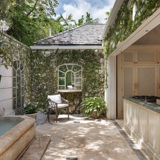 An enchanting courtyard retreat with a private plunge pool, vine-draped walls, and shaded seating—your own secluded oasis for relaxation.