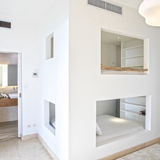 Unwind in your modern sanctuary with custom built-in sleeping nooks, seamless bathroom access, and thoughtful design touches.