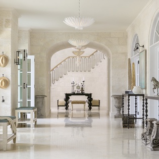 Step into refined elegance where modern chandeliers meet timeless design. Polished marble floors reflect cascading light, inviting you to unwind in this luxurious lobby sanctuary.