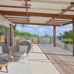 Relax in stylish wicker chairs on your private terrace, where tropical breezes and stunning ocean views create your perfect island escape.
