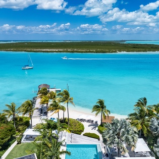 Stunning beachfront property with crystal-clear turquoise waters, private beach access, and tropical paradise setting.