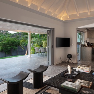 Your open-concept living space flows seamlessly to your private terrace, where tropical views and cool breezes create the perfect Caribbean escape.