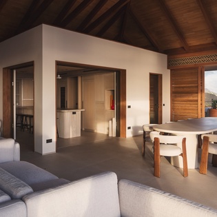 Unwind in your spacious living area with soaring wood beams, contemporary furnishings, and seamless indoor-outdoor flow to your private terrace.