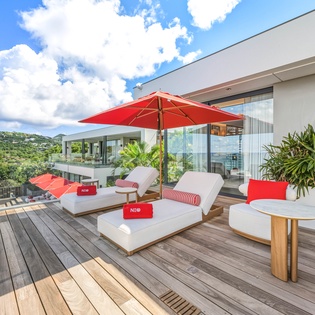 Modern rooftop terrace offers comfortable outdoor seating with mountain views and contemporary styling.
