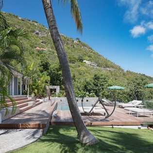 Your private tropical oasis awaits with lush palm shade, sparkling pool, and mountain views creating the perfect Caribbean escape.