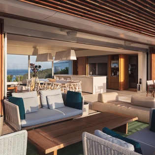 Unwind in this stunning open-concept living space where modern comfort meets coastal elegance, with panoramic ocean views framing your every moment.