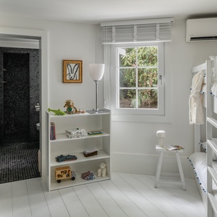 Your kids will love this bright bunk room with private bathroom and garden view windows.