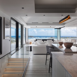 Breathtaking ocean views greet you from this sleek, modern kitchen where you'll craft meals while gazing at endless blue horizons.