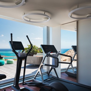 Work out while soaking in stunning ocean views through floor-to-ceiling windows in this modern fitness center.