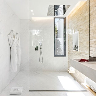 Step into your spa-like sanctuary with marble finishes, rainfall shower, and fluffy robes awaiting your arrival.