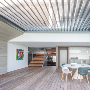 Relax in your stunning modern terrace with adjustable louvered ceiling, perfect for dining al fresco while enjoying natural light.
