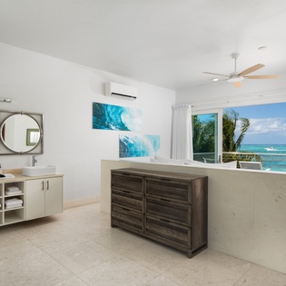 Step into your luxurious master suite where dual sinks and stunning ocean views create your perfect morning routine.
