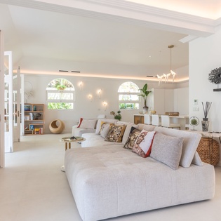 Sink into plush seating surrounded by natural light streaming through arched windows, creating your perfect retreat for morning coffee or evening relaxation.