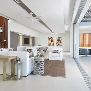 Step into your spacious open-plan living area where modern comfort meets tropical elegance, seamlessly flowing to your private terrace.