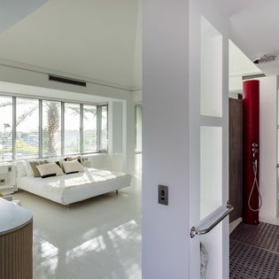 Sink into your spacious white bed as natural light filters through your panoramic windows, creating the perfect sanctuary for relaxation.