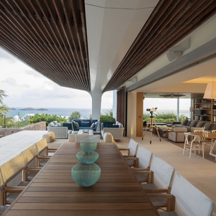 Stunning open-air dining space where you'll savor meals under the modern pergola, with ocean breezes and tropical views framing every moment.
