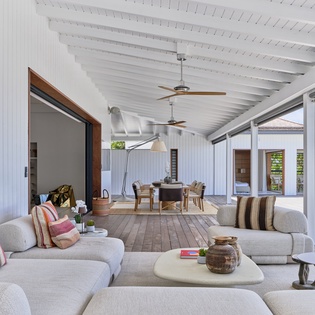 Unwind in your bright, open living space where beachside breezes and garden views flow freely. Plush seating, elegant dining, and seamless indoor-outdoor living await you.