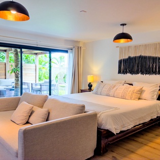 Unwind in your serene retreat with lush garden views from bed. Soft textures, warm lighting, and modern comforts make this your perfect escape.