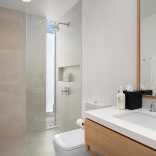 Step into your sleek spa-like bathroom with a spacious walk-in shower, elegant vanity, and premium amenities waiting for your arrival.