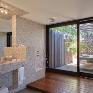 Luxurious spa-inspired bathroom with stunning outdoor shower views and mosaic tile details creates your private wellness sanctuary.