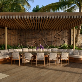 Gather under this stunning pergola where elegant dining meets tropical paradise, perfect for memorable meals surrounded by lush palms.