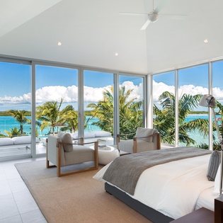 Wake up to stunning ocean views through floor-to-ceiling windows that frame turquoise waters and swaying palms perfectly.
