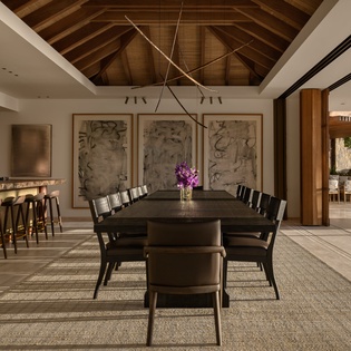 Your elegant dining space opens to outdoor seating, where warm wood beams create an intimate atmosphere for memorable meals.