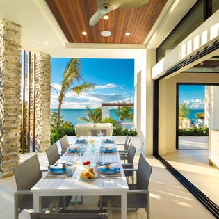 Dine under the stars in your covered outdoor space with stunning ocean views and tropical breezes—perfect for gathering with loved ones over alfresco meals and unforgettable sunsets.