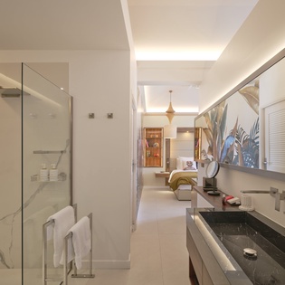 Step into your luxurious ensuite bathroom with marble-veined shower, elegant twin sinks, and sophisticated lighting that creates a spa-like retreat.