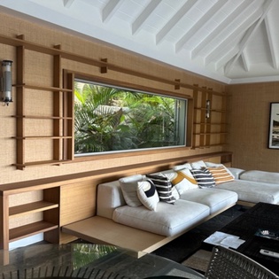 Unwind in your sophisticated living space where modern comfort meets tropical tranquility through stunning garden views.