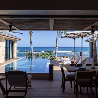 Dine overlooking your infinity pool with the ocean stretching endlessly beyond, creating the perfect backdrop for your tropical getaway.