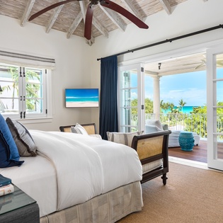 Sink into crisp linens and wake to turquoise waters framing your private balcony—your peaceful island retreat with breathtaking sea views awaits.