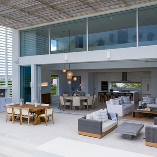 Relax in your expansive open-air living space where modern comfort meets tropical elegance, perfect for entertaining or unwinding.