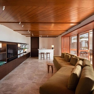 Unwind in your stylish living space featuring rich wood tones, a plush sofa, and serene views—your perfect retreat after a day exploring.
