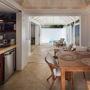 Bright open-plan kitchen and dining flow seamlessly to your private patio—perfect for morning coffee or sunset meals. Feel the breeze, enjoy home-cooked favorites, and unwind in style.