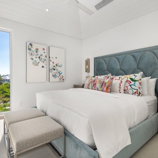 Wake up refreshed in your elegant bedroom with crisp linens and garden views through floor-to-ceiling windows.