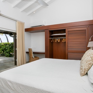 Drift off to the soothing sound of waves in this airy bedroom with ocean views. Your private workspace and storage make it easy to unwind or stay connected during your escape.
