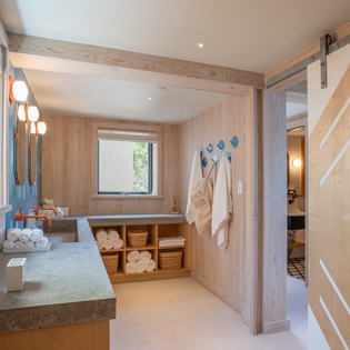 Unwind in your private spa-like bathroom with deep soaking tub, plush robes, and warm wood accents creating the perfect wellness retreat.